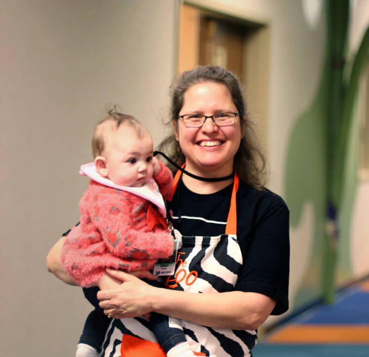 Woman - Volunteer - Holds - Infant - James River Church
